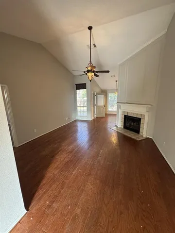 a view of a livingroom with wooden floor and a ceiling fan