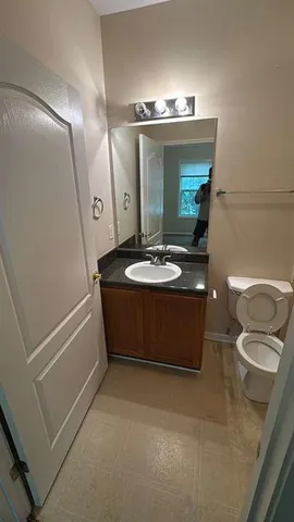 a bathroom with a sink a mirror and vanity