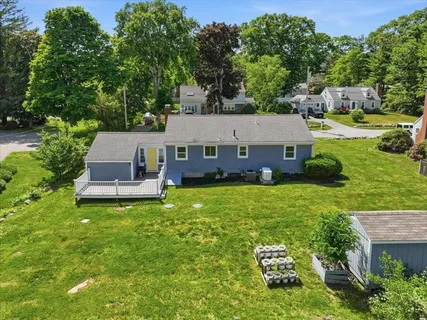 an aerial view of a house with a garden and trees