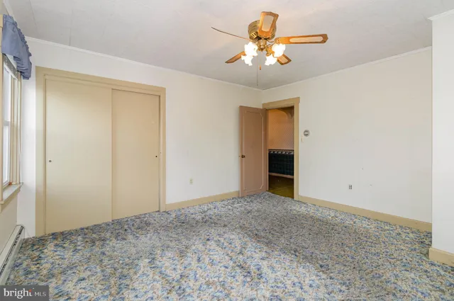 a view of a bedroom with a chandelier fan and a chandelier fan
