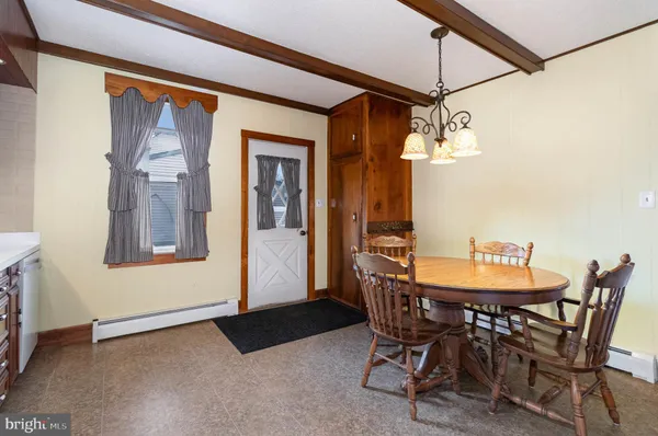 a view of a dining room with furniture and chandelier