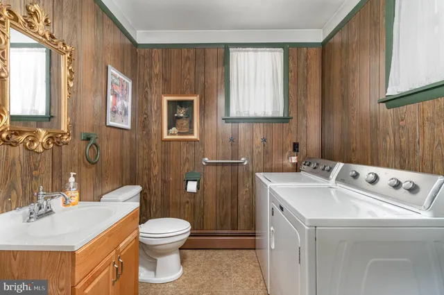 a bathroom with a sink toilet and window