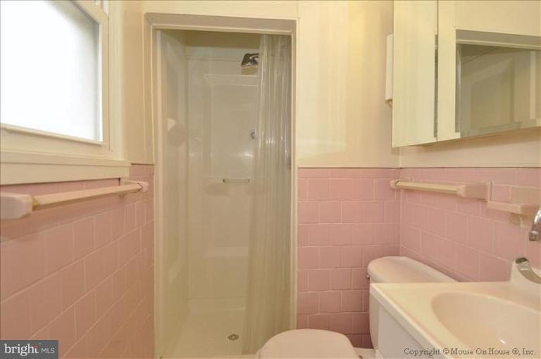 512 Harding Drive Silver Spring, MD 20901 - Photo 13 of 28 a white toilet sitting next to a bathroom sink