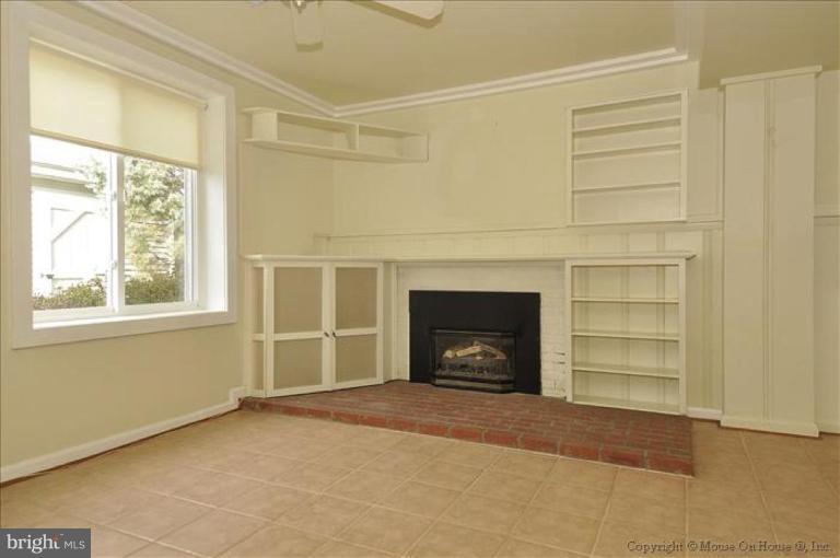 512 Harding Drive Silver Spring, MD 20901 - Photo 23 of 28 a view of an empty room with a fireplace and a window