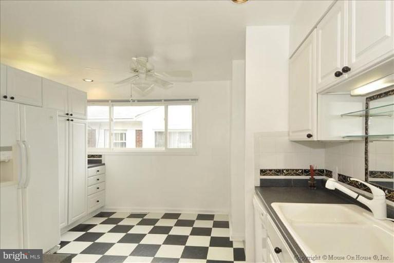 512 Harding Drive Silver Spring, MD 20901 - Photo 7 of 28 a room with a sink a window and cabinets