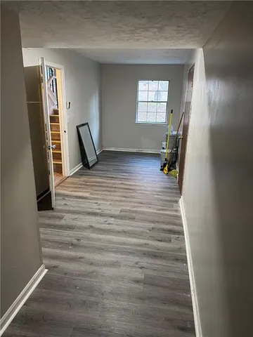 a view of a room with window and hardwood floor