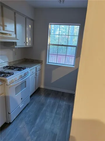 a kitchen with a stove a sink and a microwave