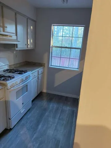 a kitchen with a stove a sink and a microwave