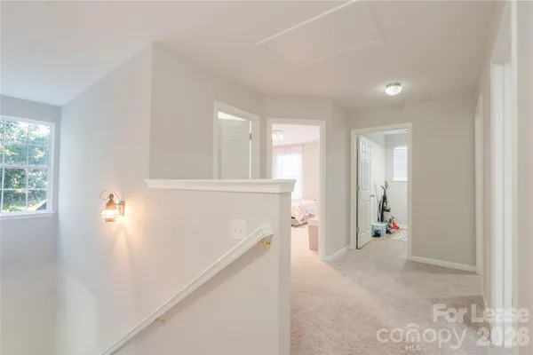 a view of hallway with furniture and a window