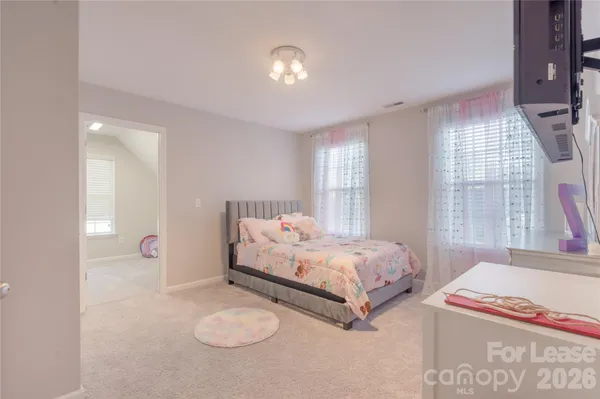 a bedroom with 2 bed and a window