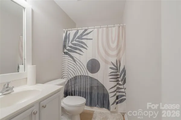 a bathroom with a sink toilet and mirror