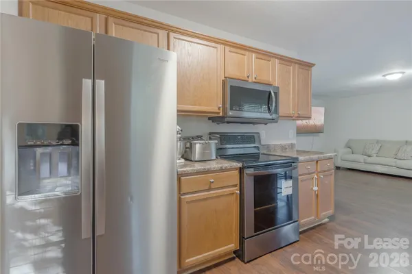 a kitchen with stainless steel appliances granite countertop a refrigerator stove and sink