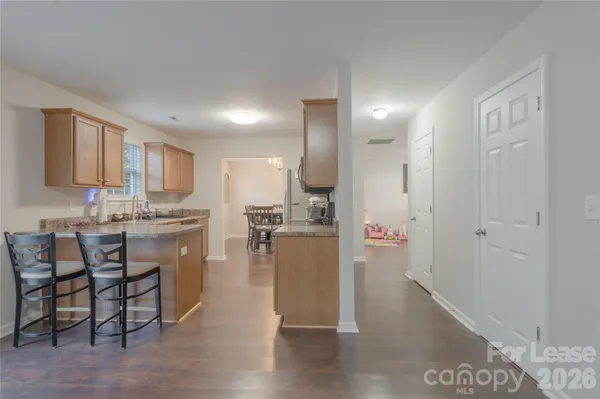 a kitchen with cabinets and wooden floor