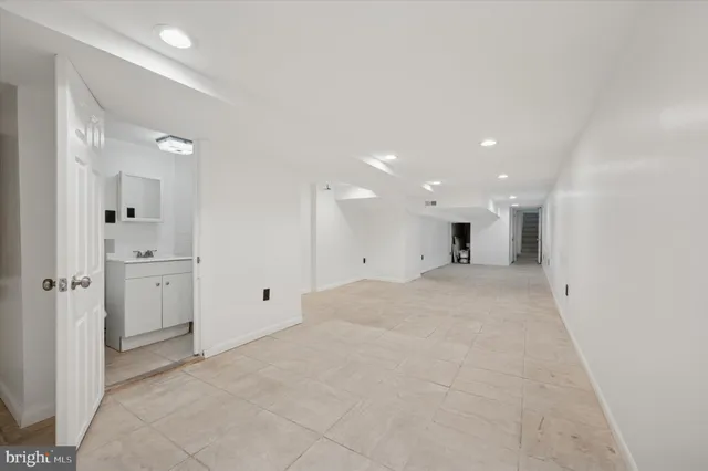 a view of a big room with white walls and windows