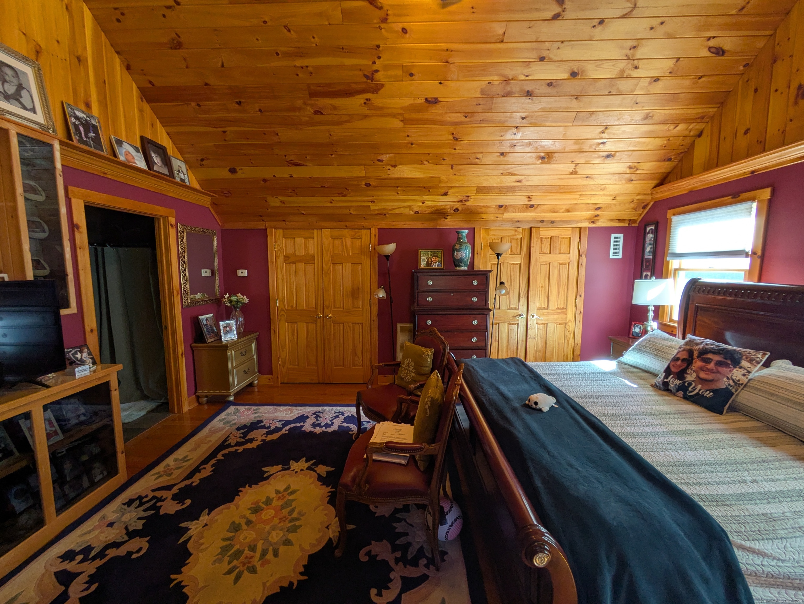 541 Benson Road Middlebury, CT 06762 - Photo 15 of 24 a bed room with a bed and a flat screen tv