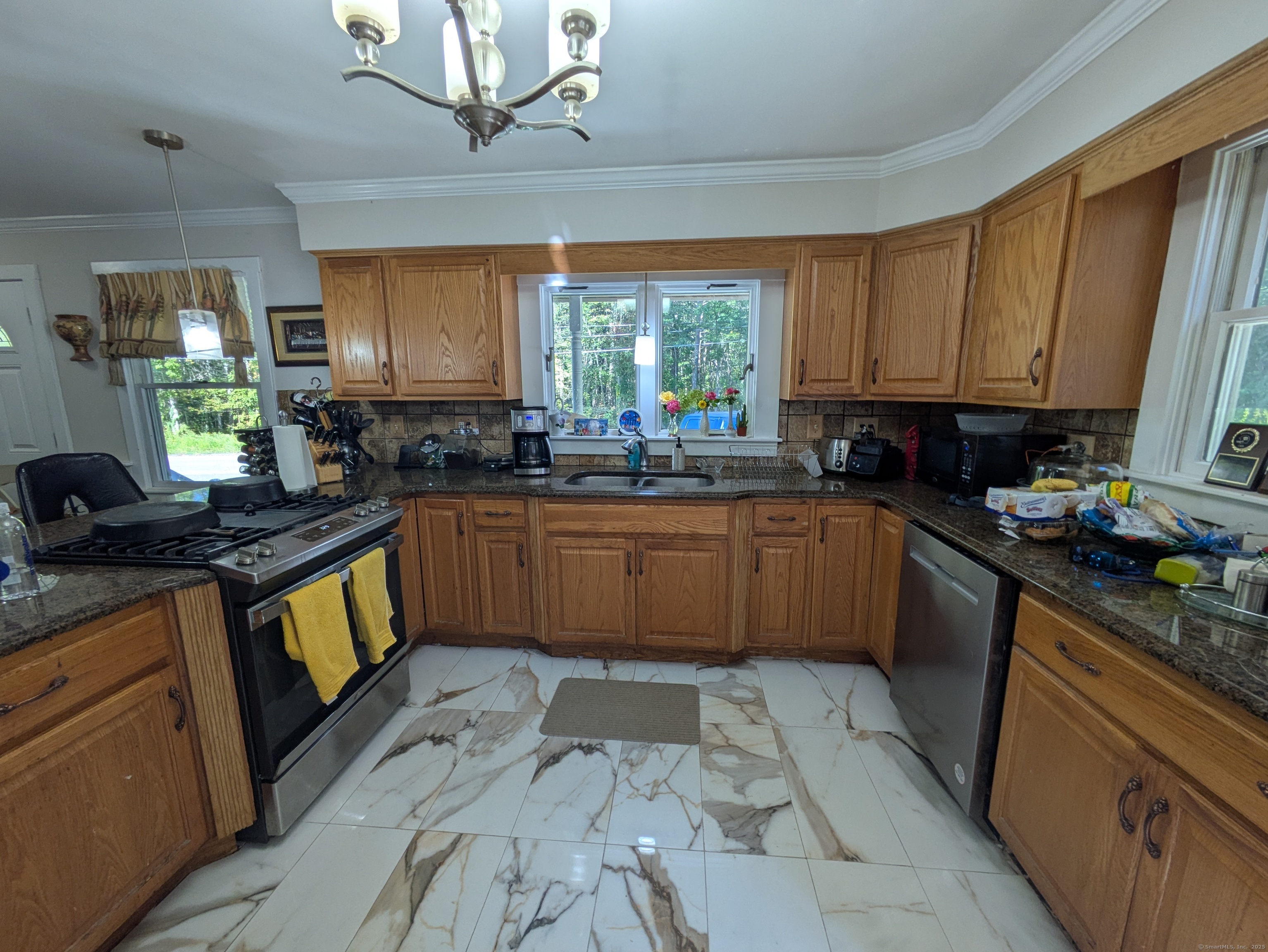 541 Benson Road Middlebury, CT 06762 - Photo 6 of 24 a kitchen with stainless steel appliances granite countertop a sink a stove top oven a counter space and cabinets
