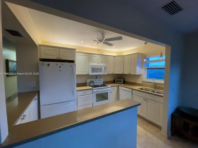 a kitchen with stainless steel appliances granite countertop a stove and a refrigerator