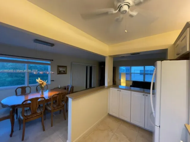 a view of dining room with furniture and a chandelier