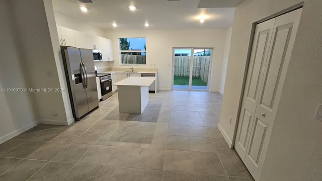 a view of a storage & utility room with a sink dryer and washer