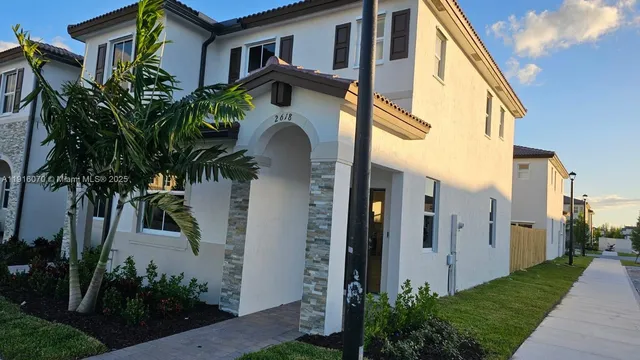 a yellow house with trees in front of it
