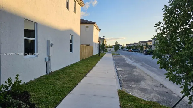 a view of a pathway with a house in the background