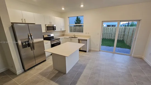 a kitchen with stainless steel appliances a refrigerator and a stove