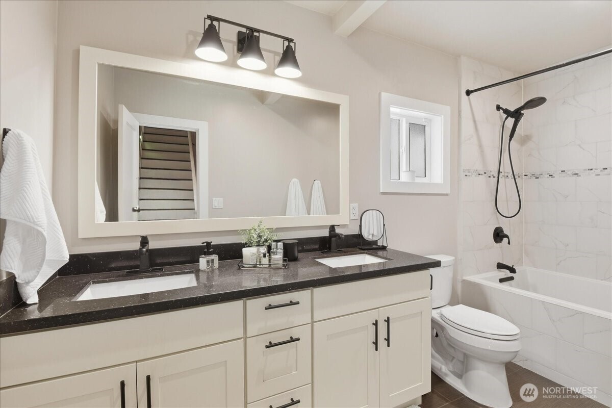 7130 Foster Slough Road Snohomish, WA 98290 - Photo 19 of 38 a bathroom with a granite countertop sink toilet a mirror and shower