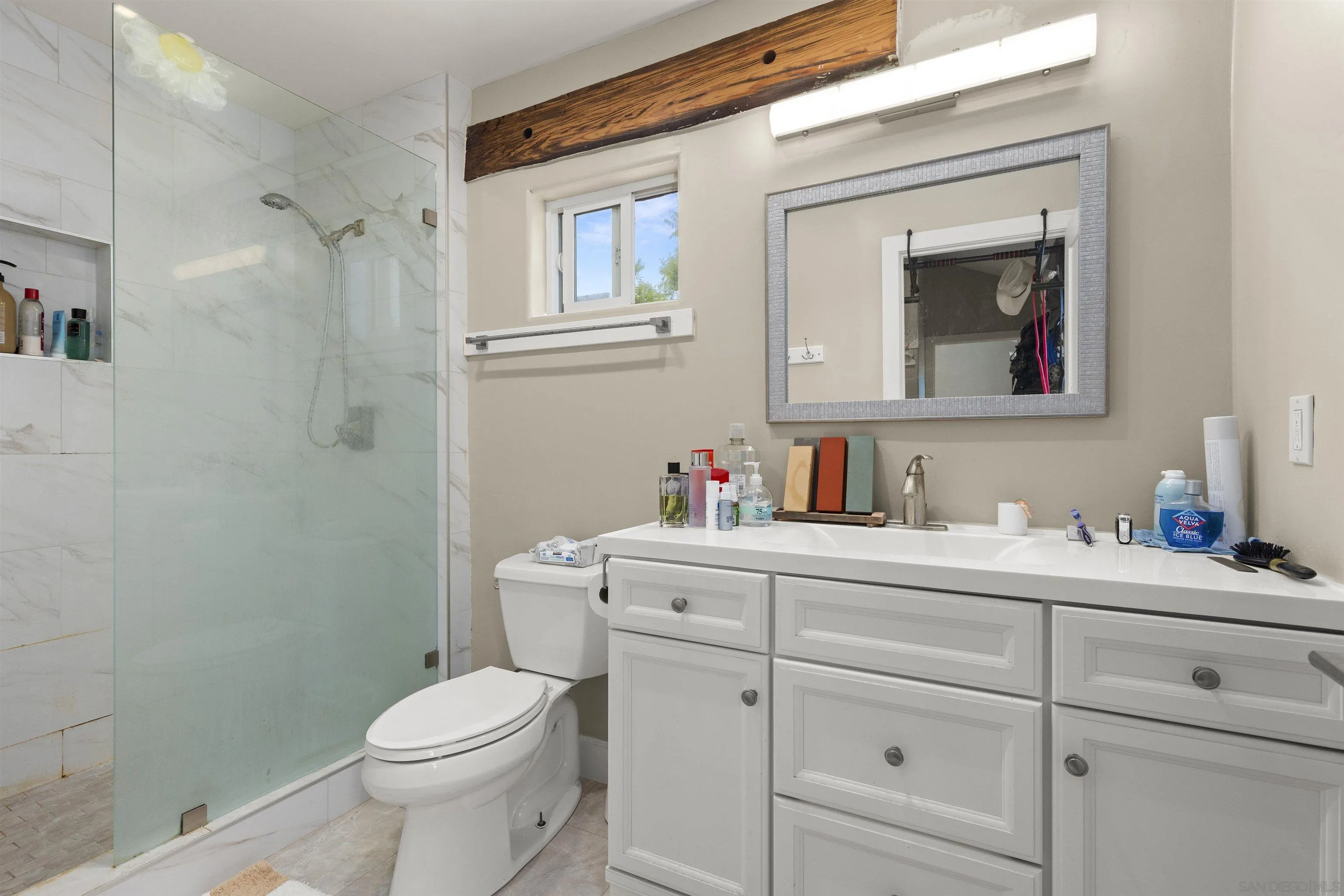 752 Bracero Road Encinitas, CA 92024 - Photo 29 of 46 a bathroom with a toilet sink vanity and mirror