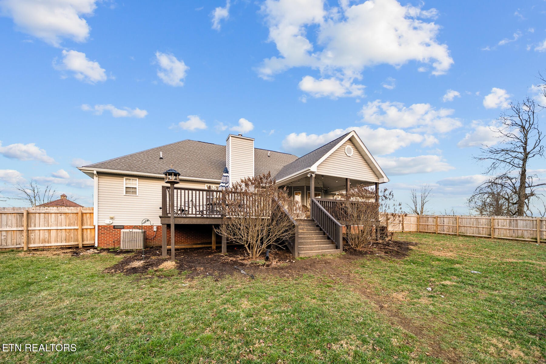 1378 Pow Camp Road Crossville, TN 38572 - Photo 41 of 59 a view of a house with a wooden fence and a big yard