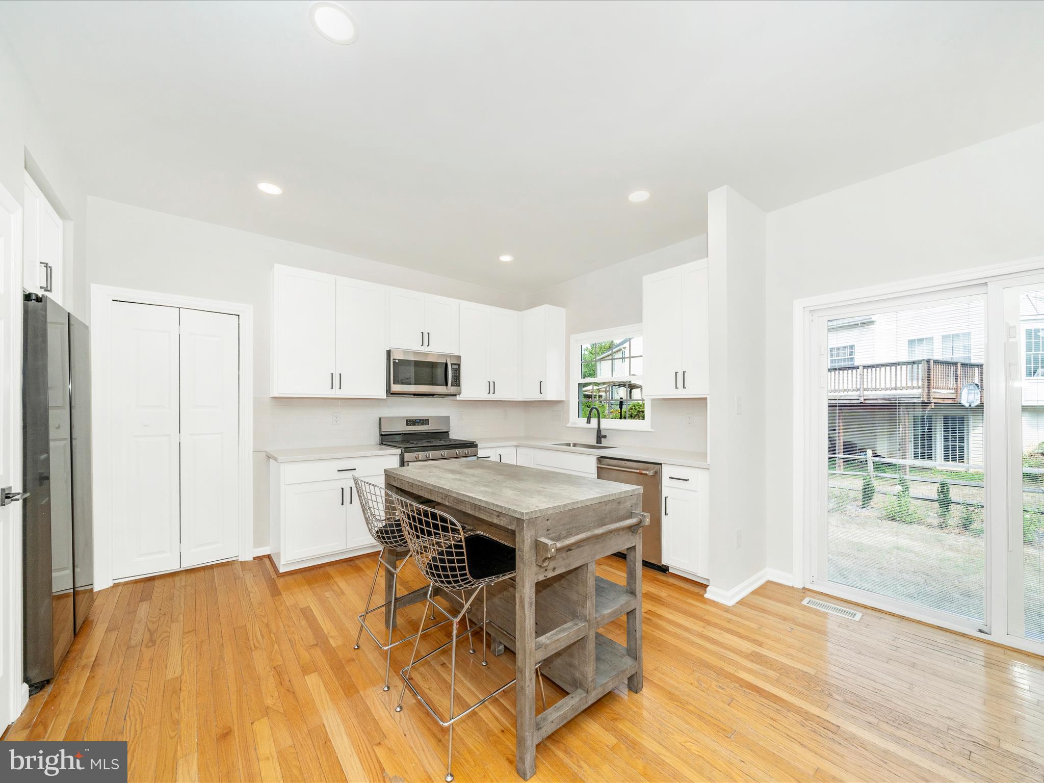 1764 Algonquin Road Frederick, MD 21701 - Photo 14 of 64 a kitchen with stainless steel appliances granite countertop a stove top oven a sink dishwasher and a refrigerator with wooden floor