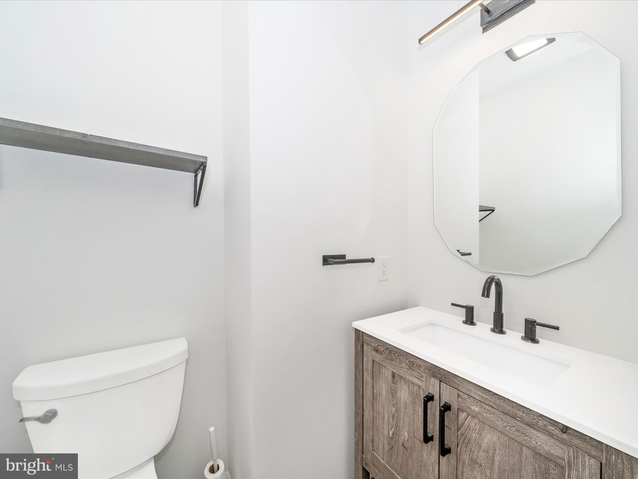 1764 Algonquin Road Frederick, MD 21701 - Photo 19 of 64 a bathroom with a toilet sink and mirror