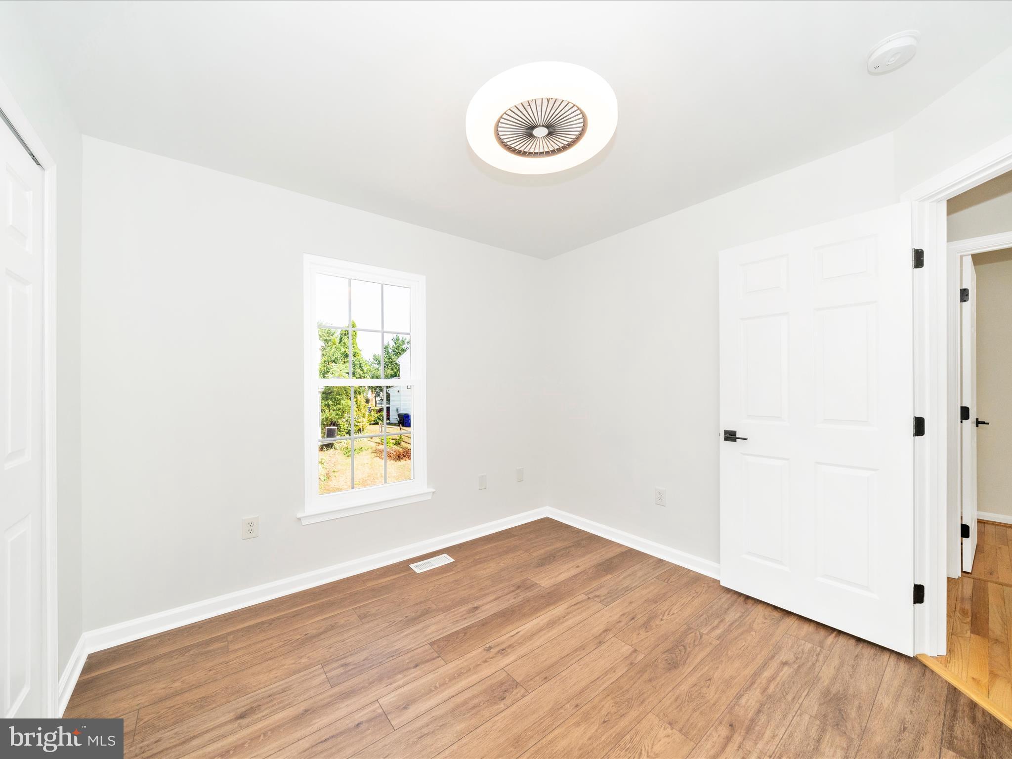 1764 Algonquin Road Frederick, MD 21701 - Photo 24 of 64 a view of an empty room with wooden floor and a window