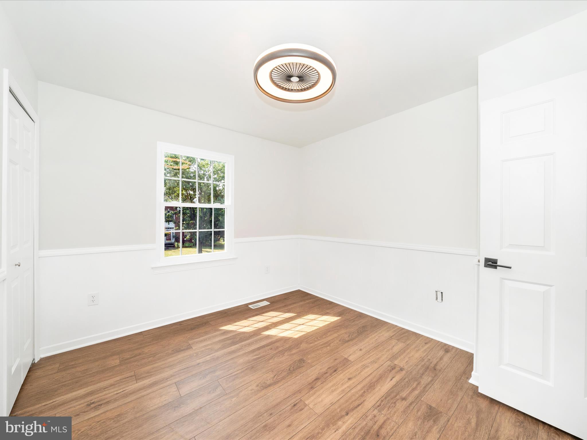 1764 Algonquin Road Frederick, MD 21701 - Photo 26 of 64 an empty room with wooden floor and windows
