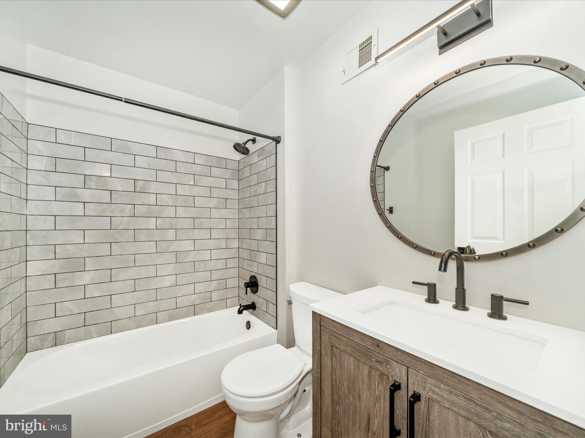 1764 Algonquin Road Frederick, MD 21701 - Photo 27 of 64 a bathroom with a sink a toilet a mirror and bathtub