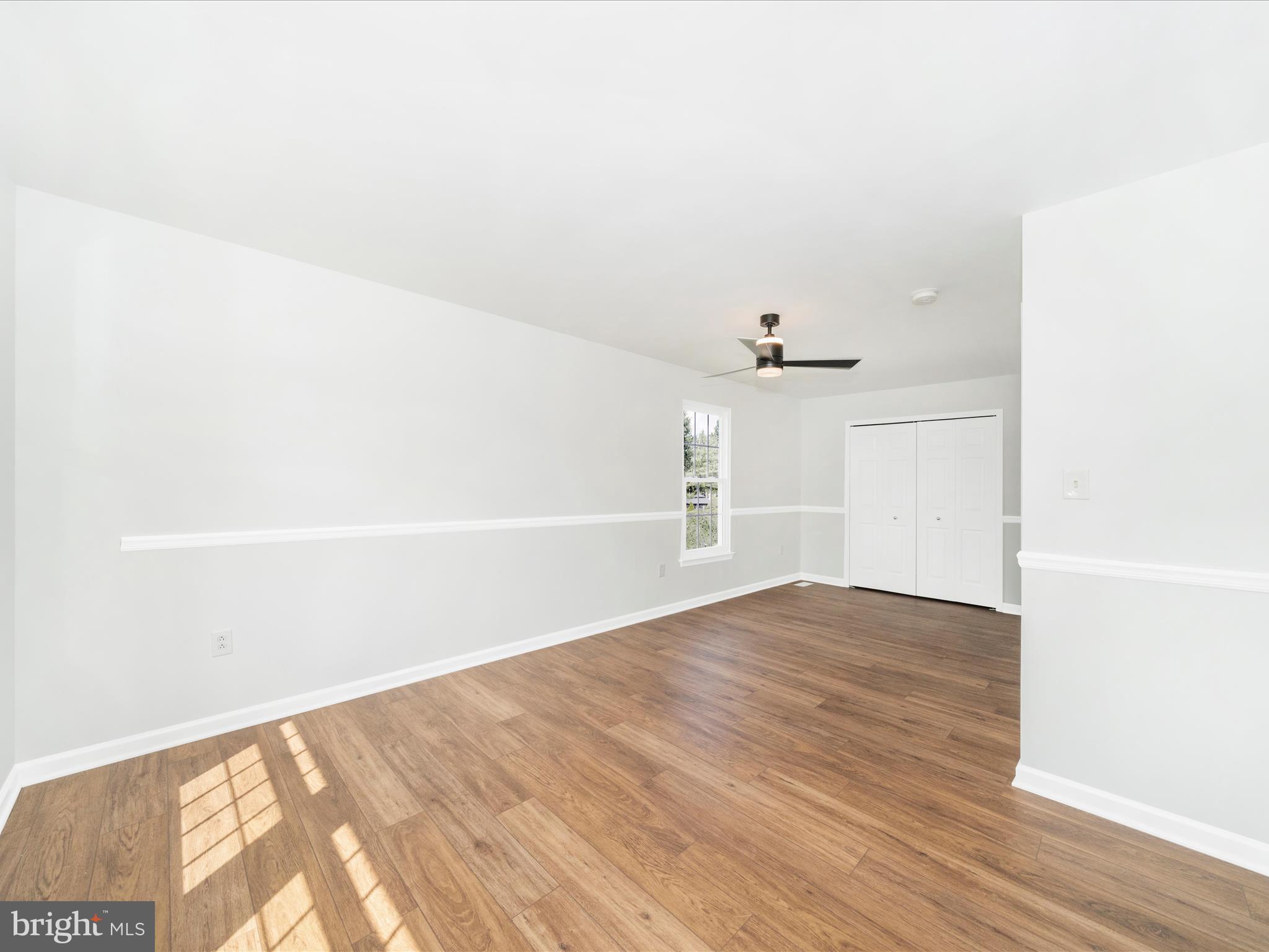 1764 Algonquin Road Frederick, MD 21701 - Photo 30 of 64 an empty room with wooden floor fan and window