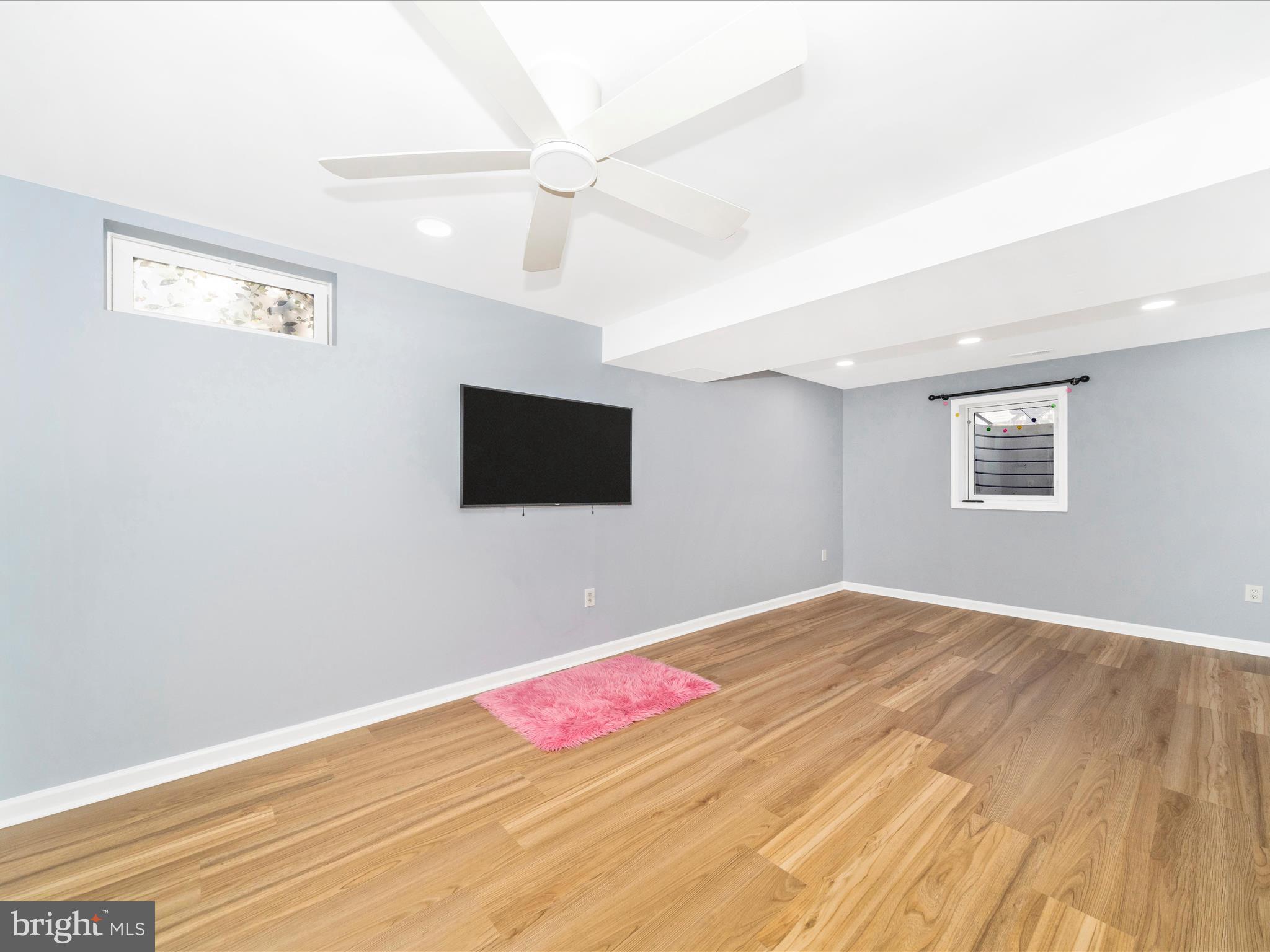1764 Algonquin Road Frederick, MD 21701 - Photo 32 of 64 a view of an empty room with wooden floor and a ceiling fan