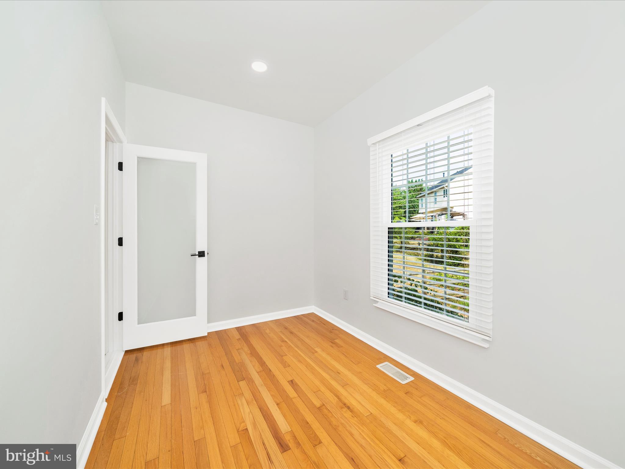 1764 Algonquin Road Frederick, MD 21701 - Photo 9 of 64 a view of an empty room with wooden floor and a window