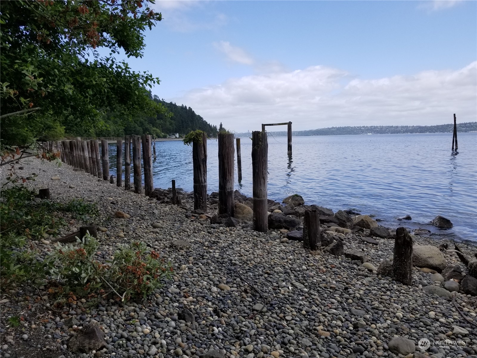 0 Cunliffe Road Southwest Vashon, WA 98070 - Photo 7 of 11 a couple of people sitting in a backyard