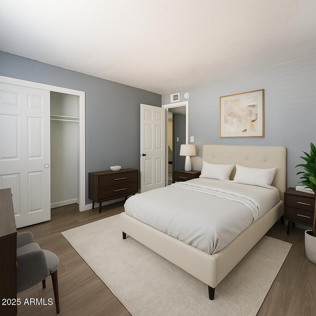 2014 West Berridge Lane Phoenix, AZ 85015 - Photo 12 of 23 a bedroom with a bed and a night stand