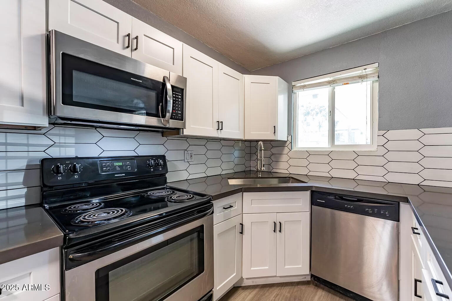 2014 West Berridge Lane Phoenix, AZ 85015 - Photo 15 of 23 a kitchen with stainless steel appliances a sink stove and microwave