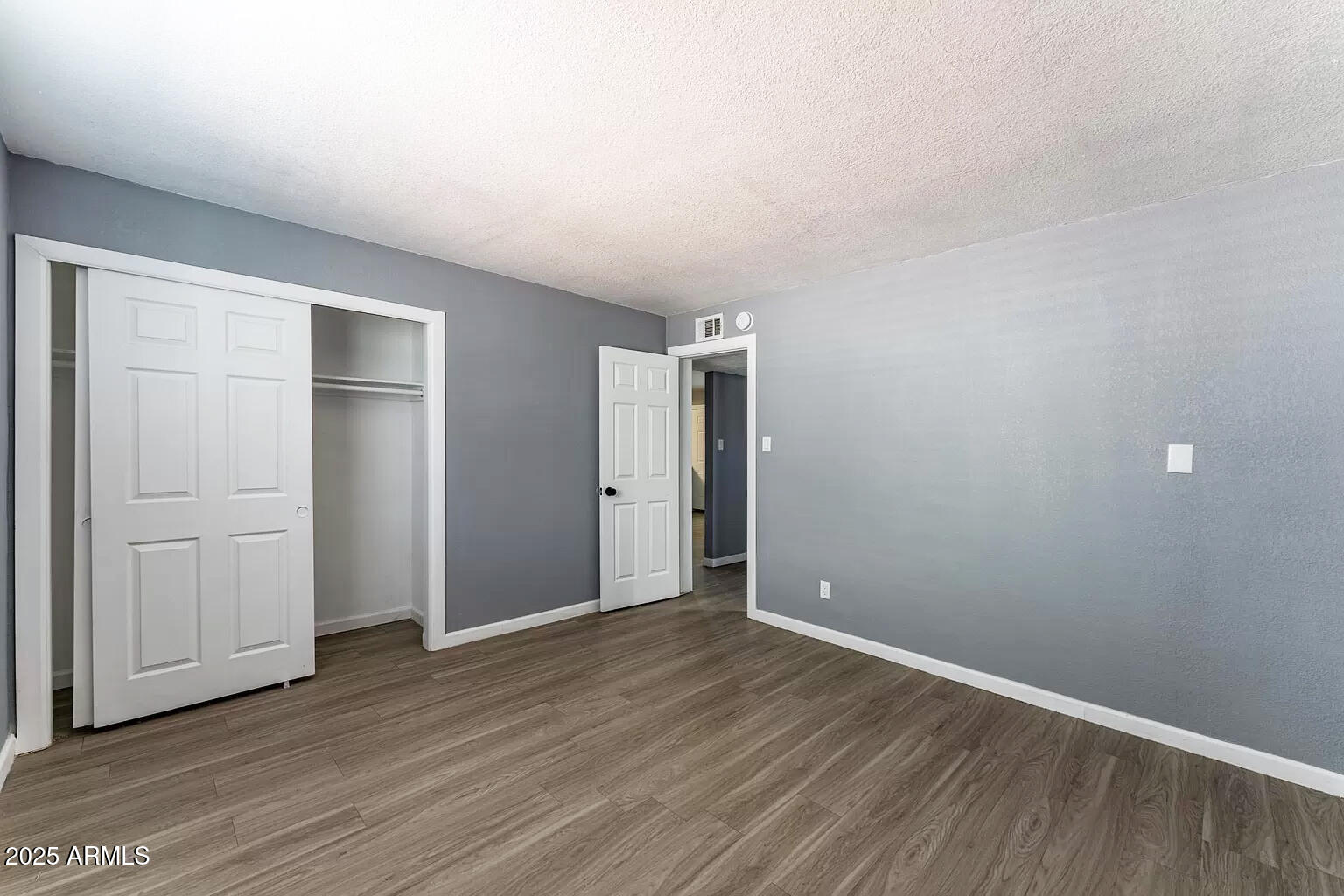 2014 West Berridge Lane Phoenix, AZ 85015 - Photo 22 of 23 a view of an empty room with wooden floor