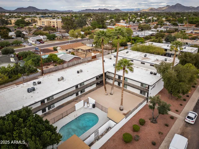an aerial view of residential houses with outdoor space and mountain view