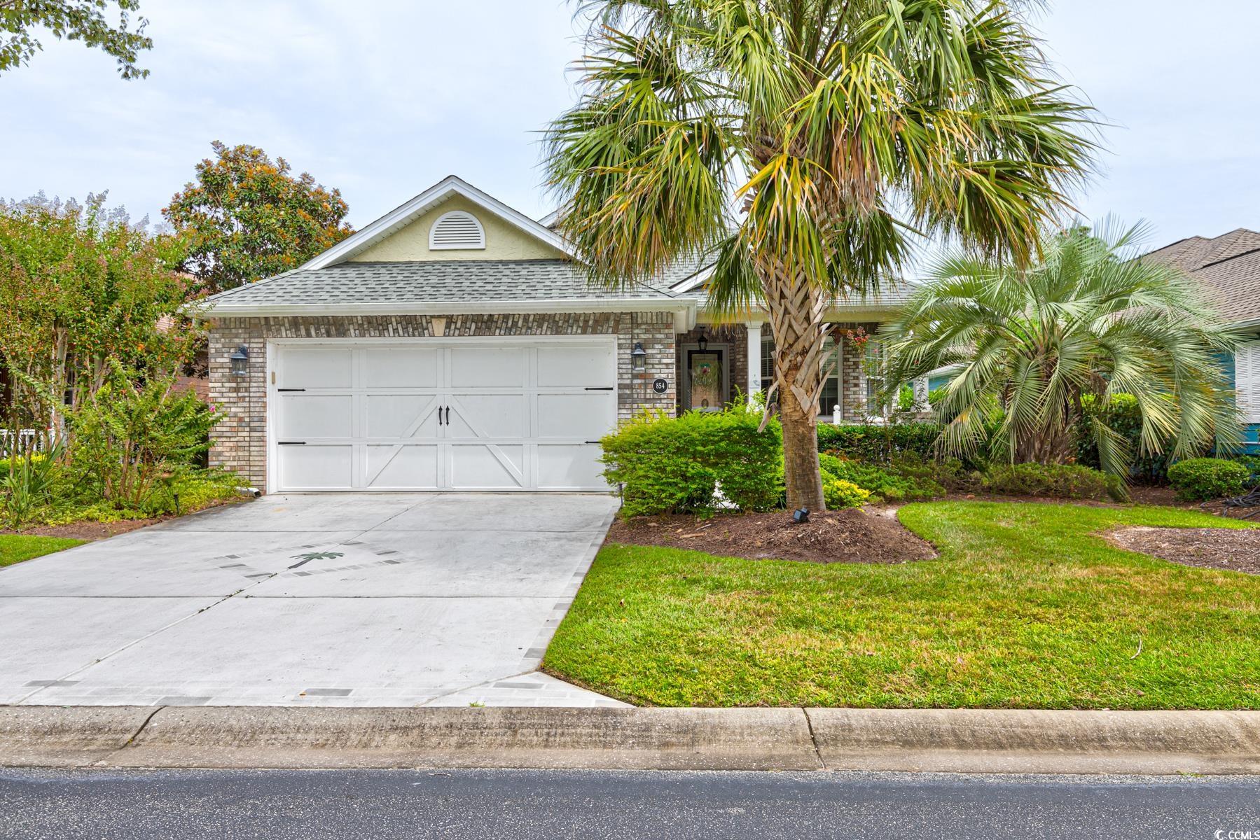 View of front of house featuring a garage and a fr
