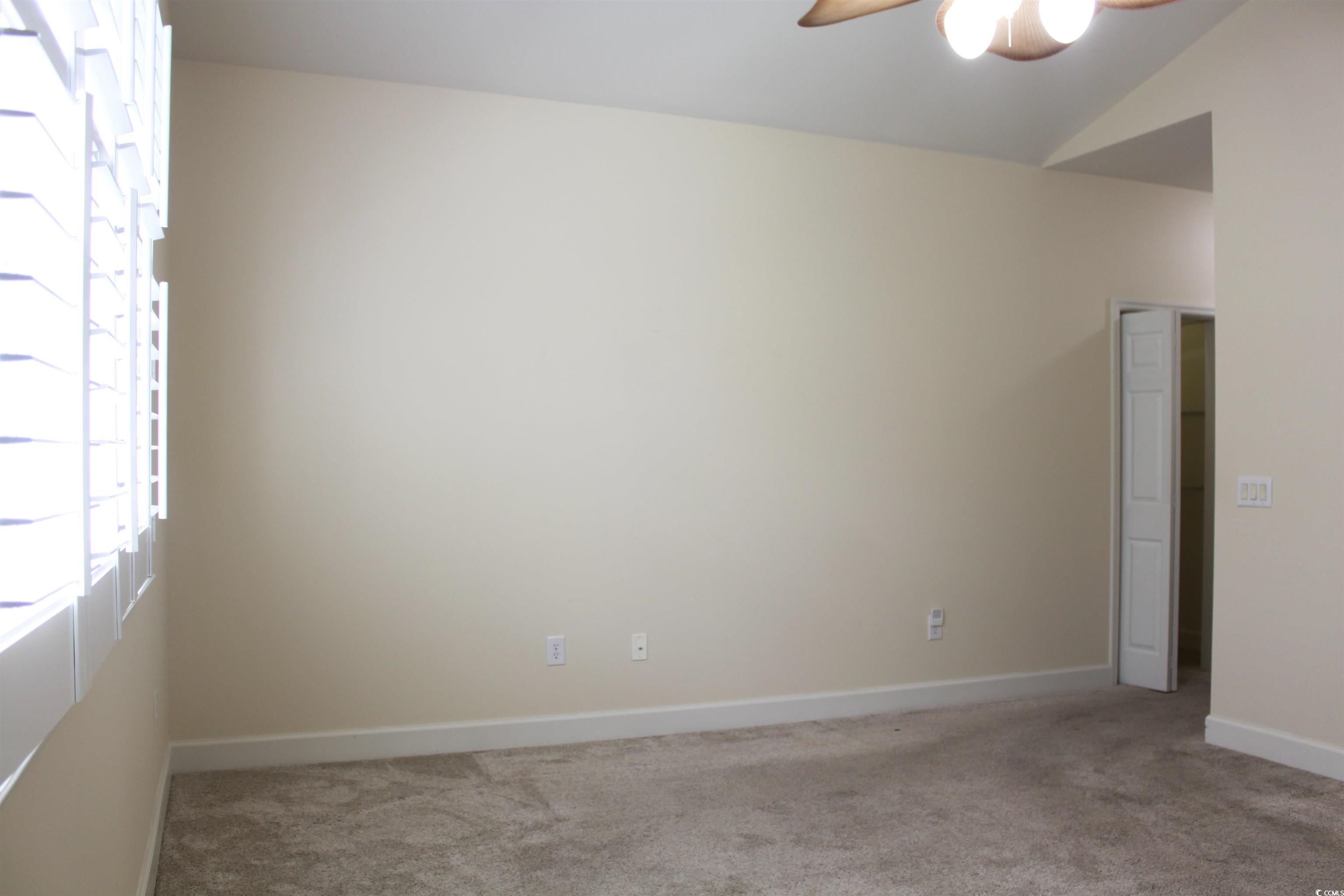 854 Laquinta Loop Murrells Inlet, SC 29576 - Photo 14 of 38 Empty room featuring vaulted ceiling, ceiling fan,