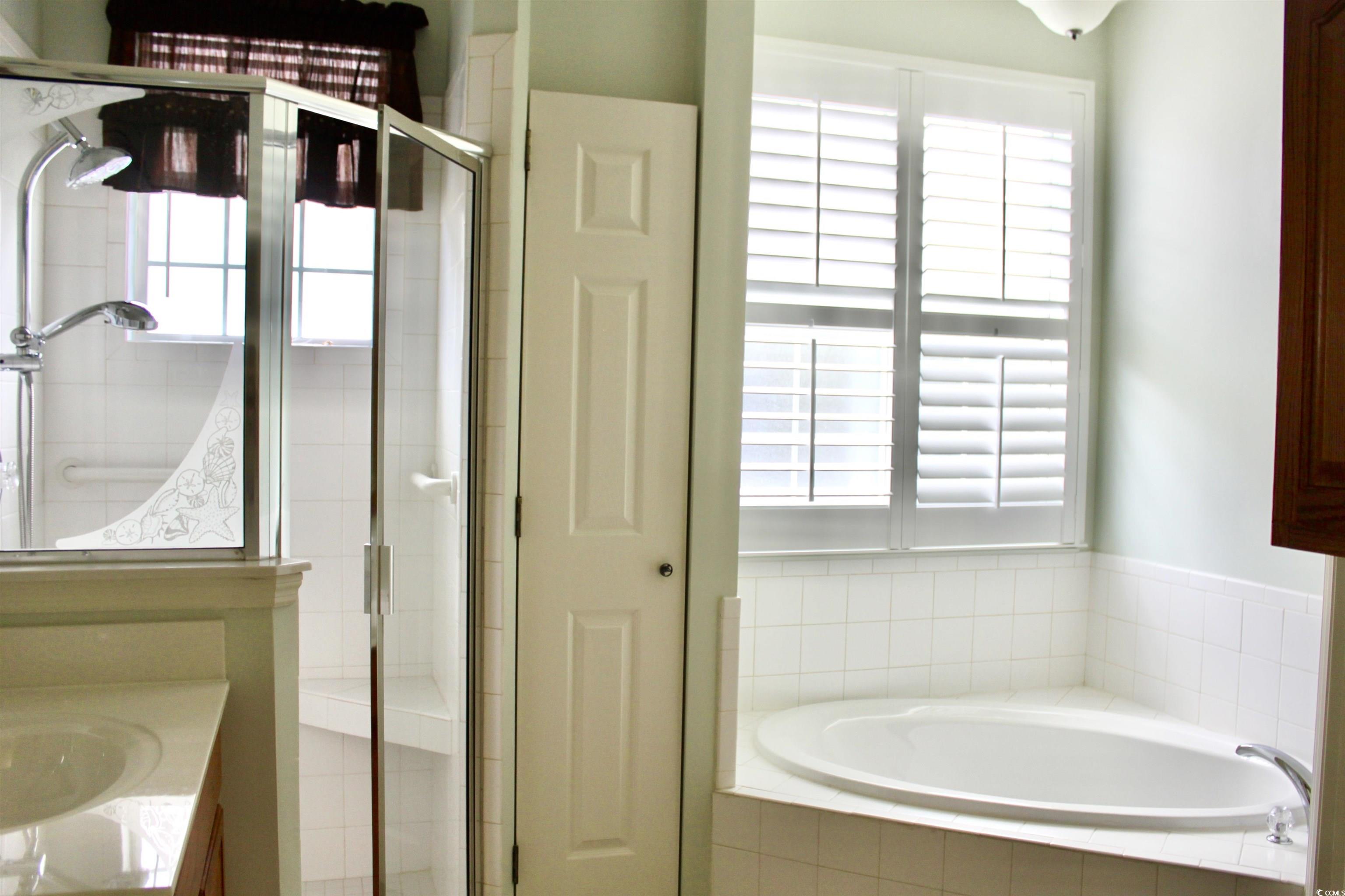 854 Laquinta Loop Murrells Inlet, SC 29576 - Photo 18 of 38 Bathroom with plus walk in shower, vanity, and a h