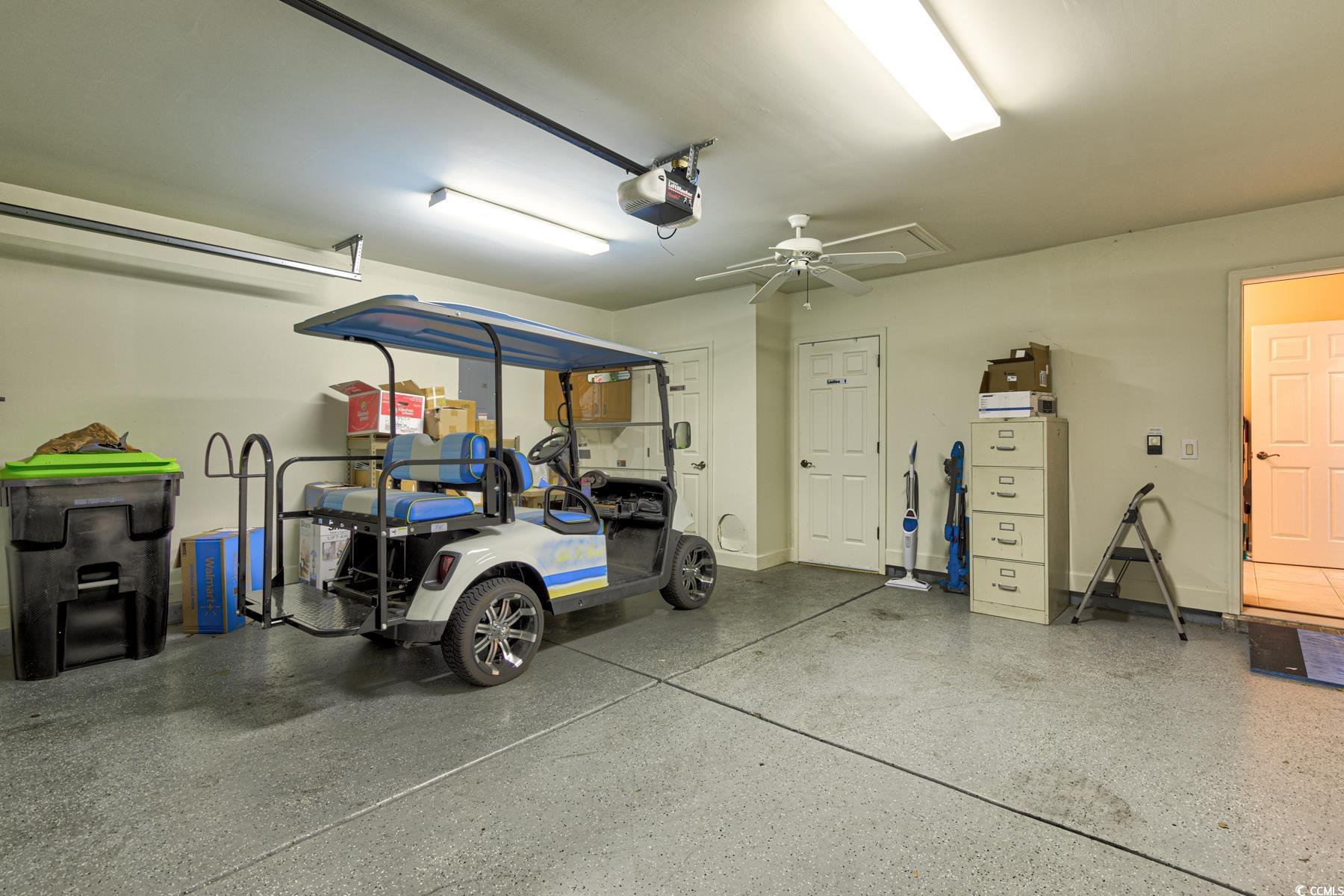 854 Laquinta Loop Murrells Inlet, SC 29576 - Photo 28 of 38 Garage with a garage door opener and ceiling fan