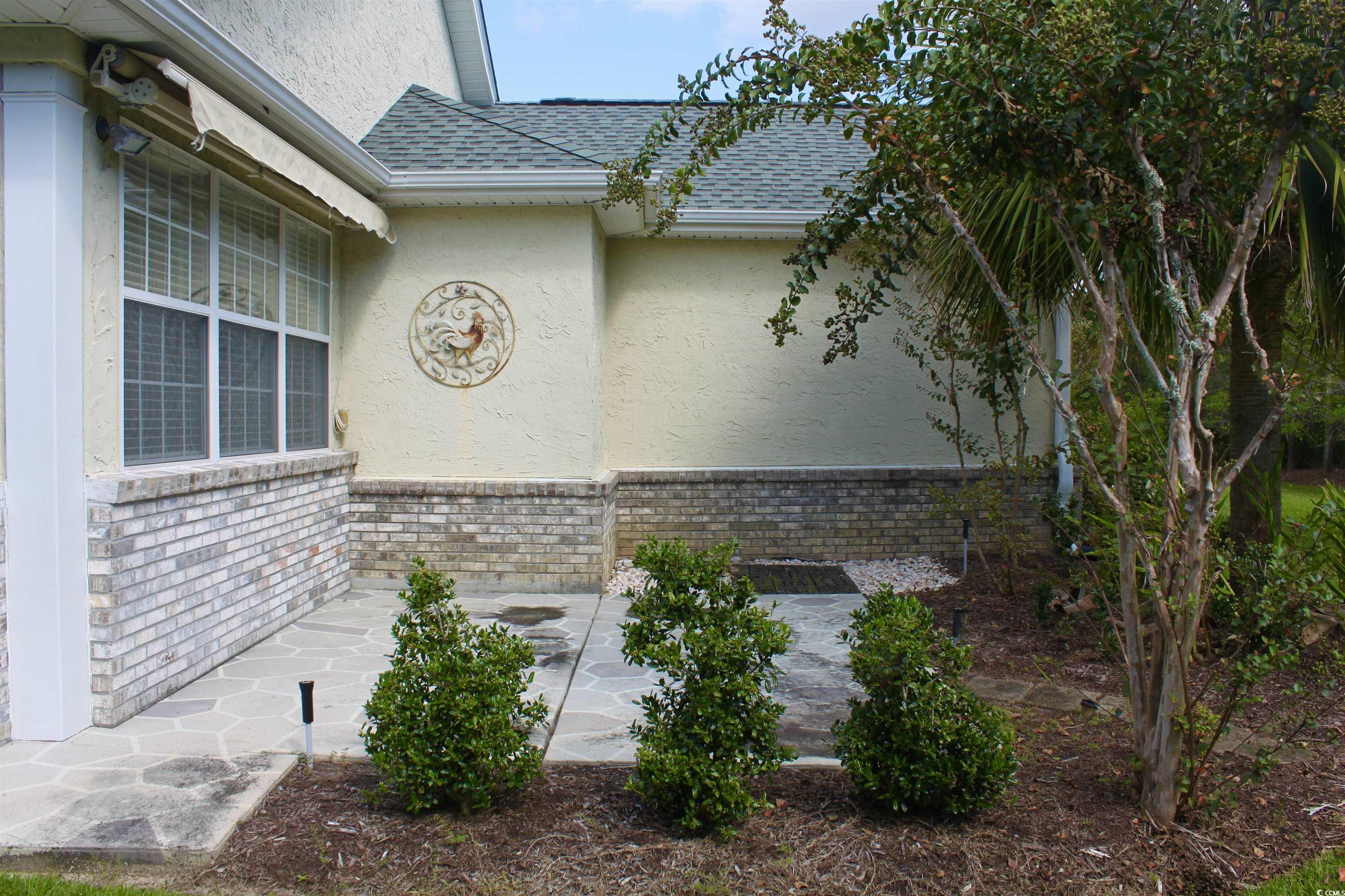 854 Laquinta Loop Murrells Inlet, SC 29576 - Photo 31 of 38 View of side of home featuring a patio area