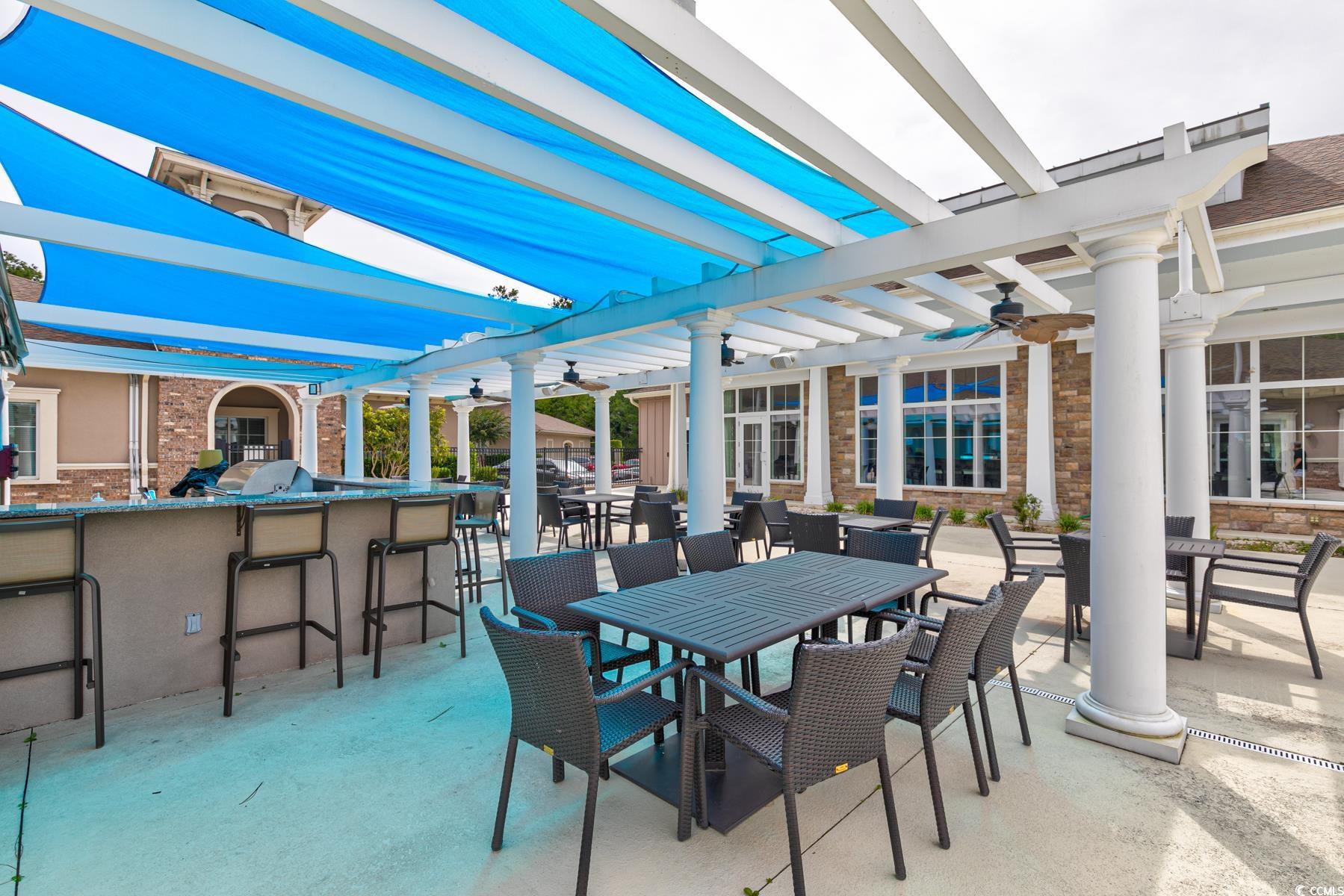 854 Laquinta Loop Murrells Inlet, SC 29576 - Photo 36 of 38 View of patio featuring exterior bar and a pergola
