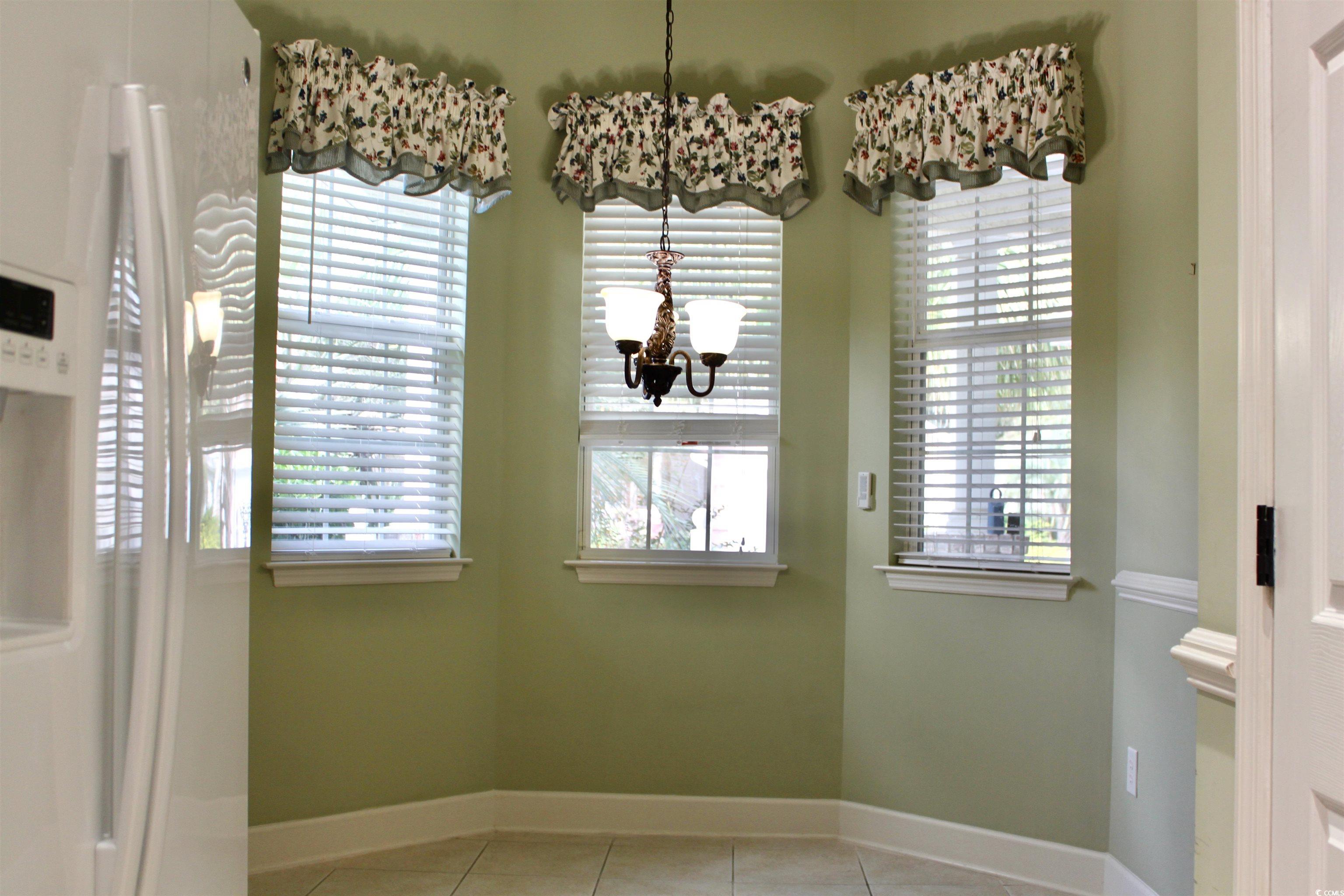 854 Laquinta Loop Murrells Inlet, SC 29576 - Photo 5 of 38 Unfurnished dining area featuring light tile patte