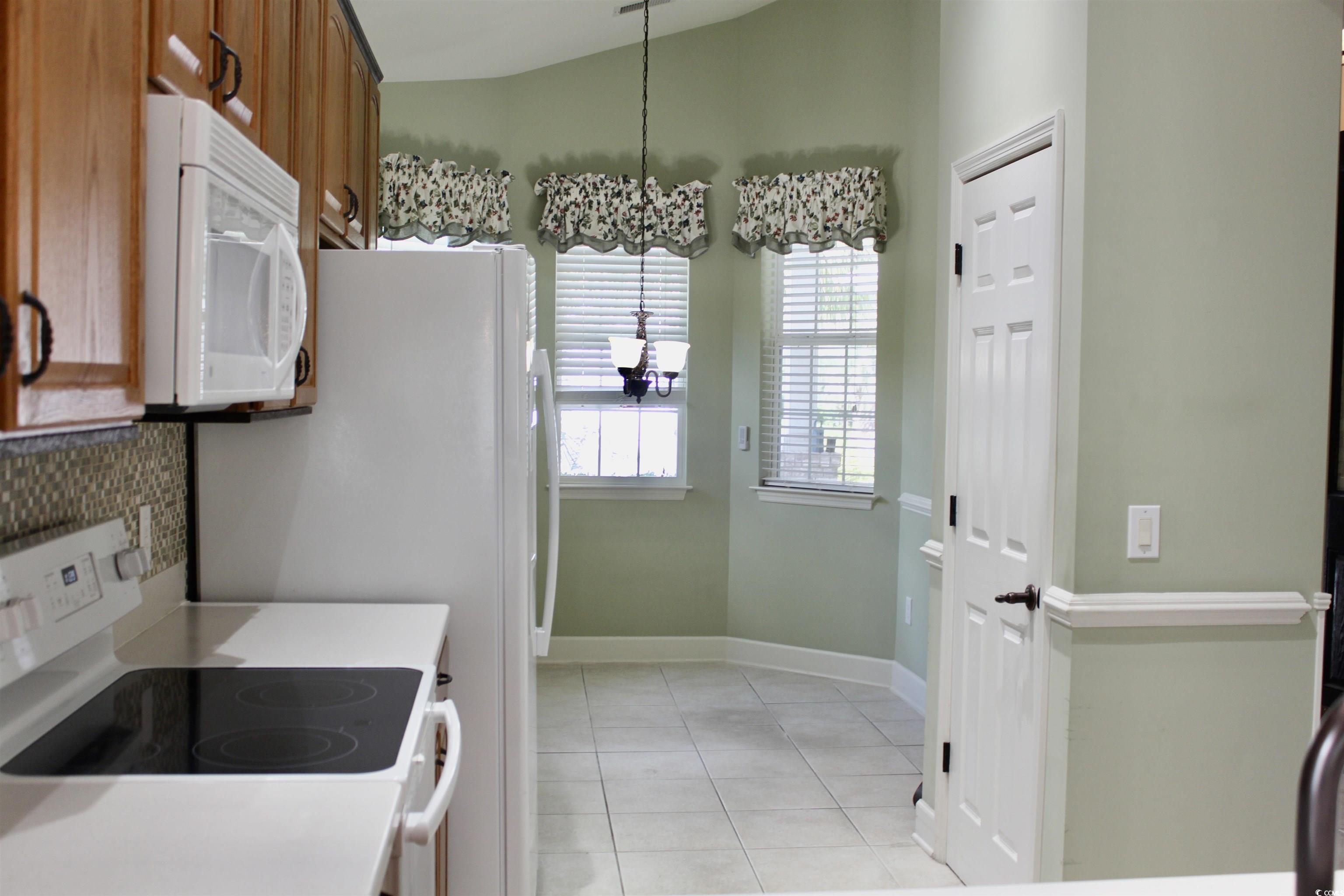 854 Laquinta Loop Murrells Inlet, SC 29576 - Photo 6 of 38 Kitchen featuring a chandelier, light tile pattern